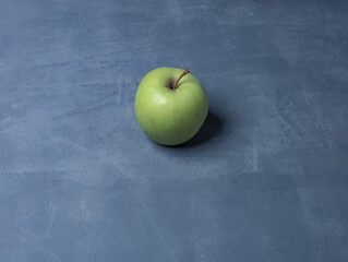 green apple golden on gray table - 478021667