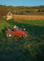 old red motorcycle near the corn field