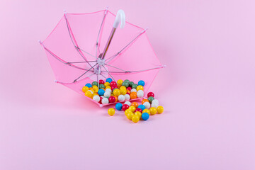 Upturned umbrella with caramel candy. Concept for Dia de Reyes Magos day (Three Wise Men) or Epiphany day. Copy space.