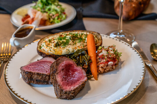 Holiday dinner of prime rib, carrots and baked potato