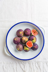 Organic fresh figs in bowl on white kitche table
