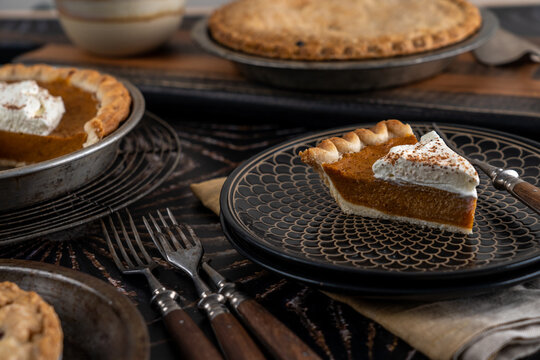 Assortment of holiday pies on dark surface