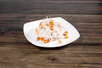 Asian cuisine salad Tashkent with crackers and radish