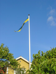 A long Swedish flag flying above a house in Karlskrona, Sweden