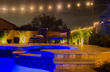 A night time view of a desert landscaped backyard in the American southwest.