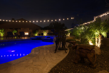 A night time view of a desert landscaped backyard in the American southwest.