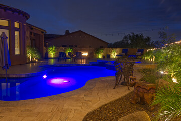 A night time view of a desert landscaped backyard in the American southwest.