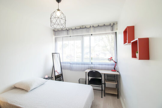 Small Student Room. White Bed, Desk And Black Chair