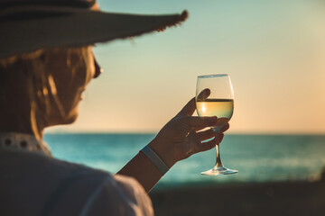 Wine glasses at sunset on the beach. Selective focus.