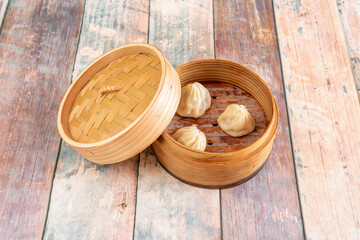 Xiaolongpao, a baozi-type stewed dumpling, is a very common culinary specialty of eastern China, including Shanghai and Wuxi. These stewed buns are usually steamed in bamboo baskets