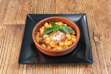 The gnocchi, with mashed potatoes mixed with soft wheat flour, basil leaves, pine nuts, garlic and salt, and mixing the pasta with Parmesan cheese, Sardinian fiore cheese and extra virgin olive.
