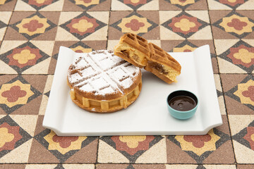The stuffed waffle is a waffle specialty from the metropolis of Lille and, in general, from French Flanders. It is an oval-shaped waffle, which opens in two to insert a flavor