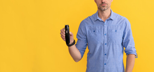 man holding electric shaver. grizzled guy presenting electric razor. haircare and shaving.
