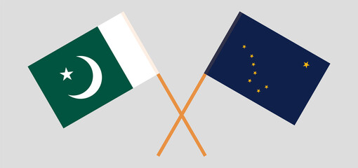 Crossed flags of Pakistan and the State of Alaska. Official colors. Correct proportion