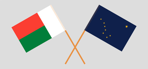Crossed flags of Madagascar and the State of Alaska. Official colors. Correct proportion
