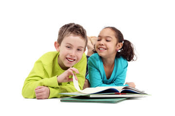 Fototapeta na wymiar Two grade school children reading a book laying down