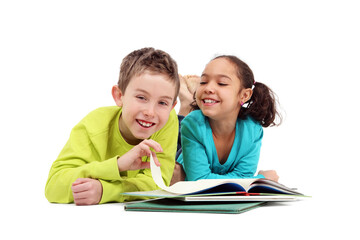 Fototapeta na wymiar Two grade school children reading a book laying down