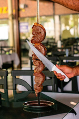 Barbecue steak
in a steakhouse and wood-fired oven
traditional cut of Brazilian beef. Meat served on the plate.