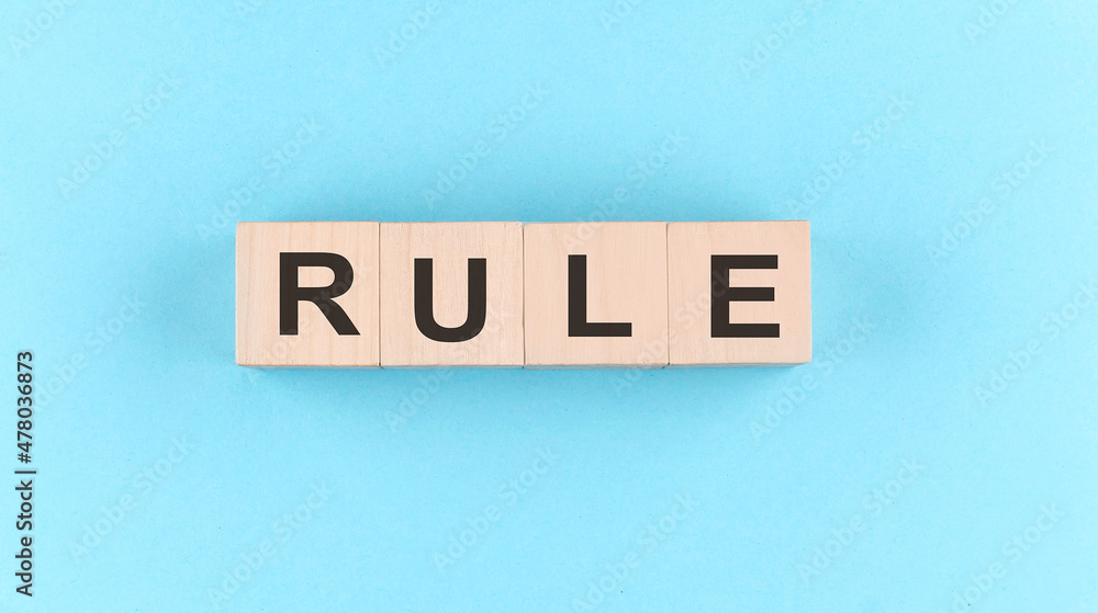 Aufkleber wooden cube block with text rule on the blue background