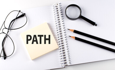 Word PATH on the sicker on notebook with pencils,magnifier and glasses