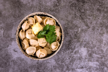 Boiled meat dumplings served with butter. Top view.