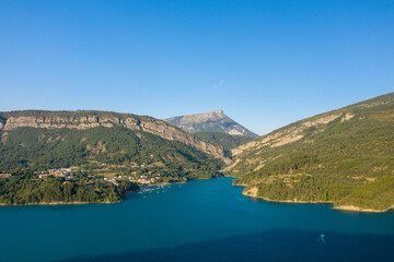 Fototapeta premium The Lac de Castillon surrounded by mountains and forests in Europe, France, Provence Alpes Cote dAzur, Var, in summer, on a sunny day.