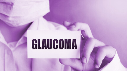 Doctor in medical clothes on a light background with the text Glaucoma. Selective focus. Medical...