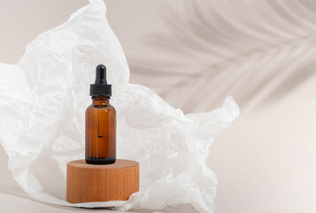 Mockup cosmetic face serum brown glass bottle with a pipette on a stylish minimalist beige white...
