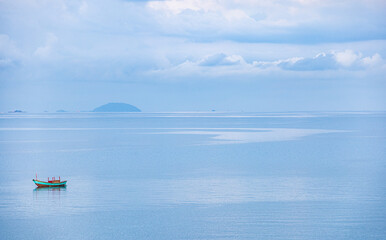 Obraz premium panorama one boat alone in the blue sea. Concept of alone in natural