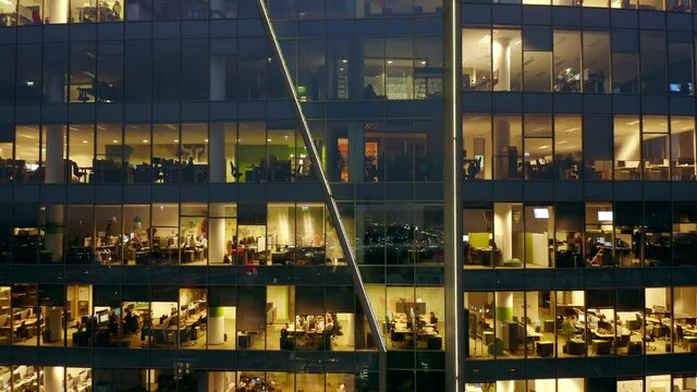 Aerial view of office windows of skyscrapers at night, International Business Center, Gdansk. Young creative people, businessmen, work at computers until late at night. Close-up of fifis windows 