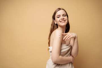 Obraz premium After spa body care. Clean skin portrait uses cream and scrub to moisturize.