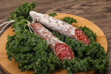 Spanish Fuet sausage with salad leaves