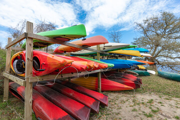 Lots of multi colored kayaks parked in storage rack