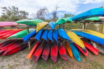 Lots of multi colored kayaks parked in storage rack