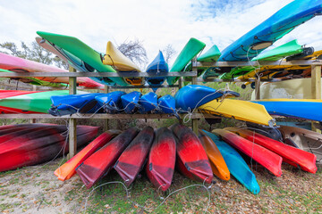 Lots of multi colored kayaks parked in storage rack