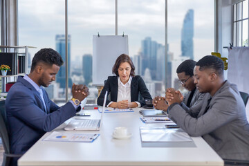 Team of diversity business people praying together before the meeting for asking god's favor for...