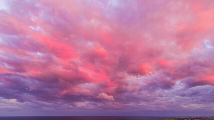 Naklejka na ściany i meble Stylized Drone shot of Minnamurra Mystics Beach Sunset Clouds Shellharbour Australia