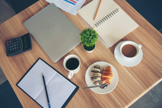 Meeting room Office laptop business financial document chart , graph on wooden table with coffee cup. Flat lay notebook computer laptop on office desk. No people business graph chart on meeting table