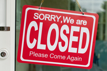 Red sorry we are closed sign hang on the door