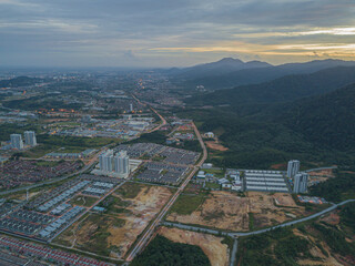 Drone shot from high angle view of residential area with many houses in Chemor, Ipoh, Perak, Malaysia.