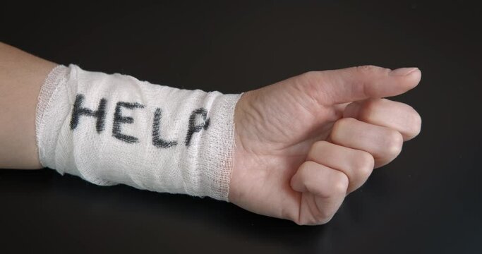 Help for suicide problems. A woman with bandaged hand need for help in loneliness. A concept of stopping the suicide.