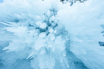 Ice cave with huge icicles on the Lake Baikal in winter. Siberia, Russia. Winter in nature.