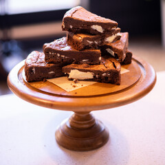 A stack of chocolate brownies on wooden background, homemade bakery and dessert