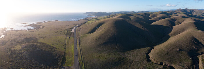 Afternoon sunlight shines on coastal hills in Central California, not far from Morro Bay. This scenic region, between Los Angeles and San Francisco, is a popular tourist destination.