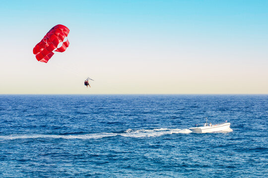 Red Parasail Wing Pulled By A Boat.  Positive Human Emotions, Feelings, Family, Travel, Vacation.