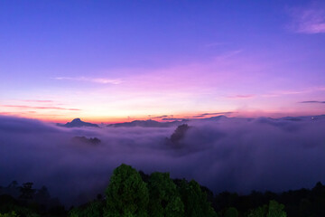 The beautiful early morning sky with twilight and waves of fog of Baan Ja Bo village viewpoint Pang...
