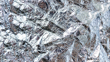 foil background. Selective focus. Metal surface.
Holographic foil texture. crumpled foil texture

