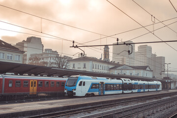 Fototapeta premium Modern electric train waiting on the staion of Ljubljana on a winter evening, waiting to start commuter service towards Kocevje, Slovenia.