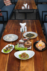 Assorted of different dishes. Georgian, Armenian and Russian cuisine. Ajara khachapuri, dolma, salad Olivier, Eggplant rolls, Khinkali, grilled meat 