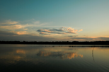 Beautiful sunset on the river bank,  blue sky and yellow sunlight. landscape during sunset